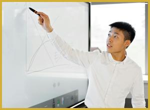 a picture of ezra playing around at the white board which matches his character very well